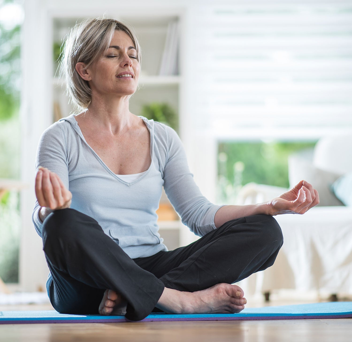 blonde woman doing a yoga position