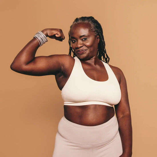 woman flexing her arm and smiling