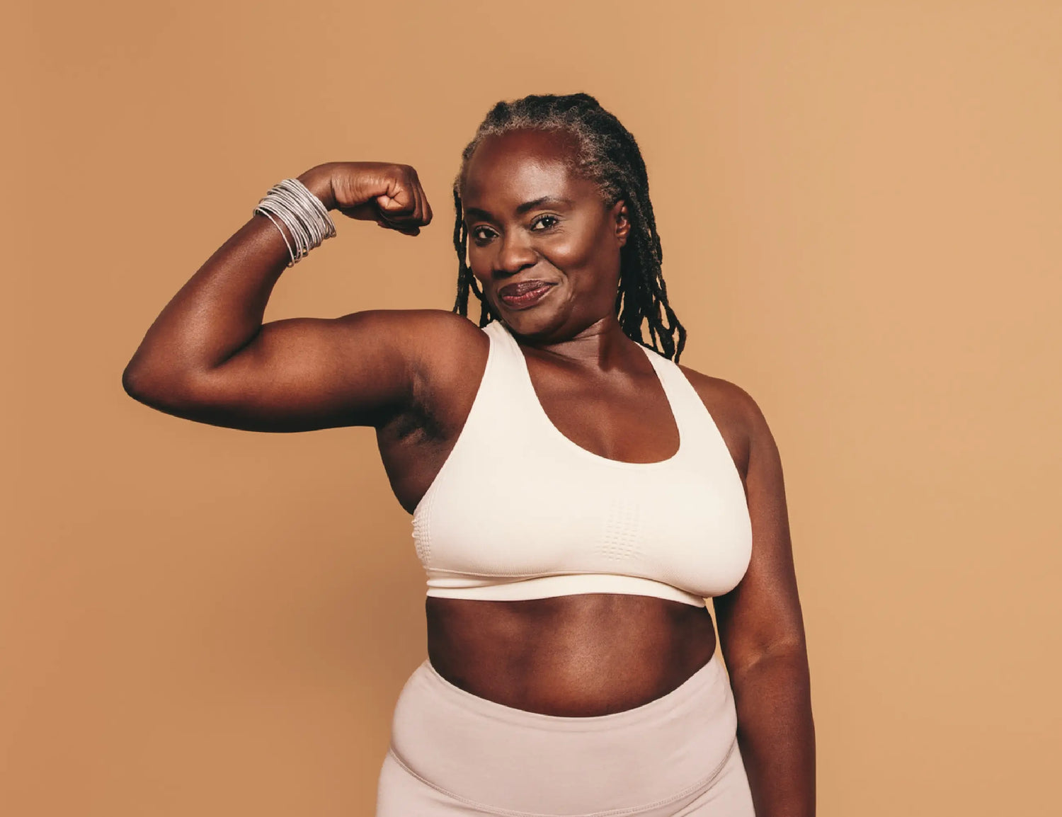 woman flexing her arm and smiling